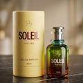 Shy Soleil perfume bottle and packaging on a reflective surface with a blurred background